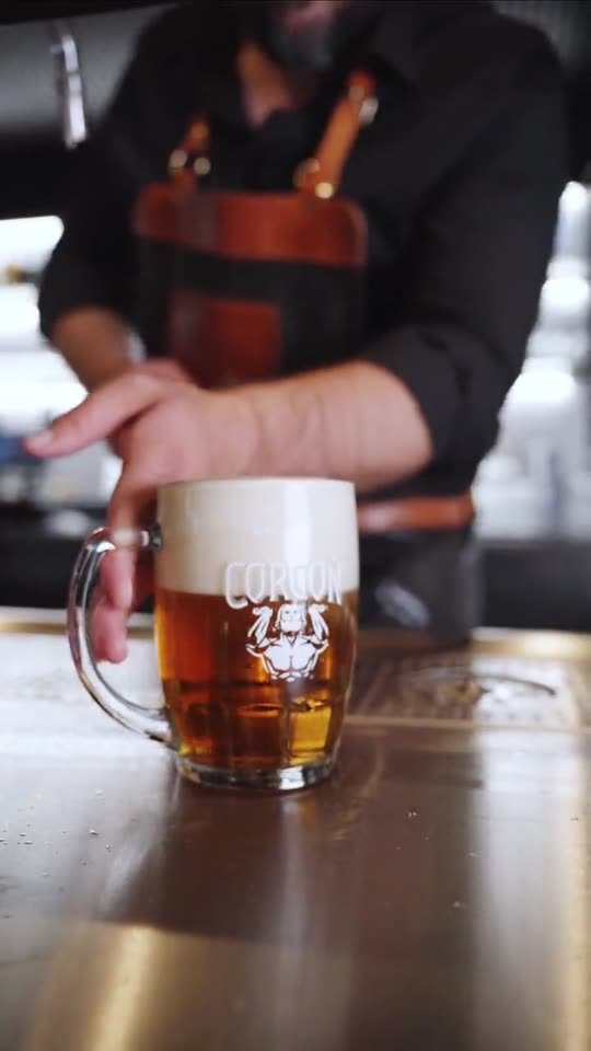 Výčapník ukladá načapované pivo na bar